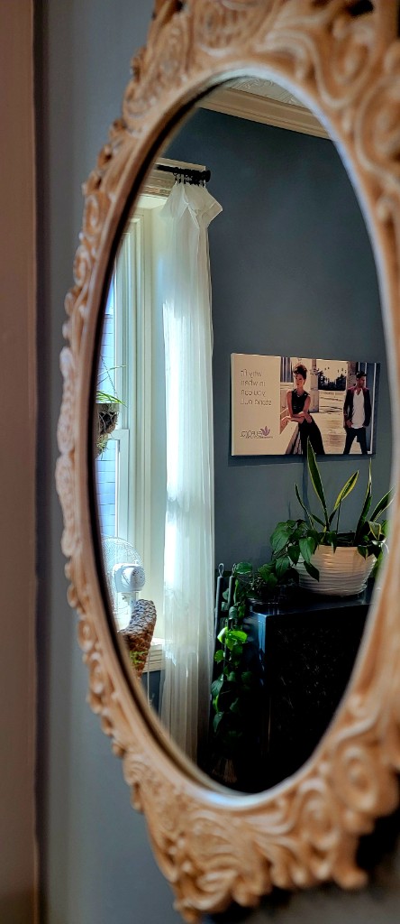 Ornate oval mirror and soft interior detail inside Joseph's Styling Salon.
